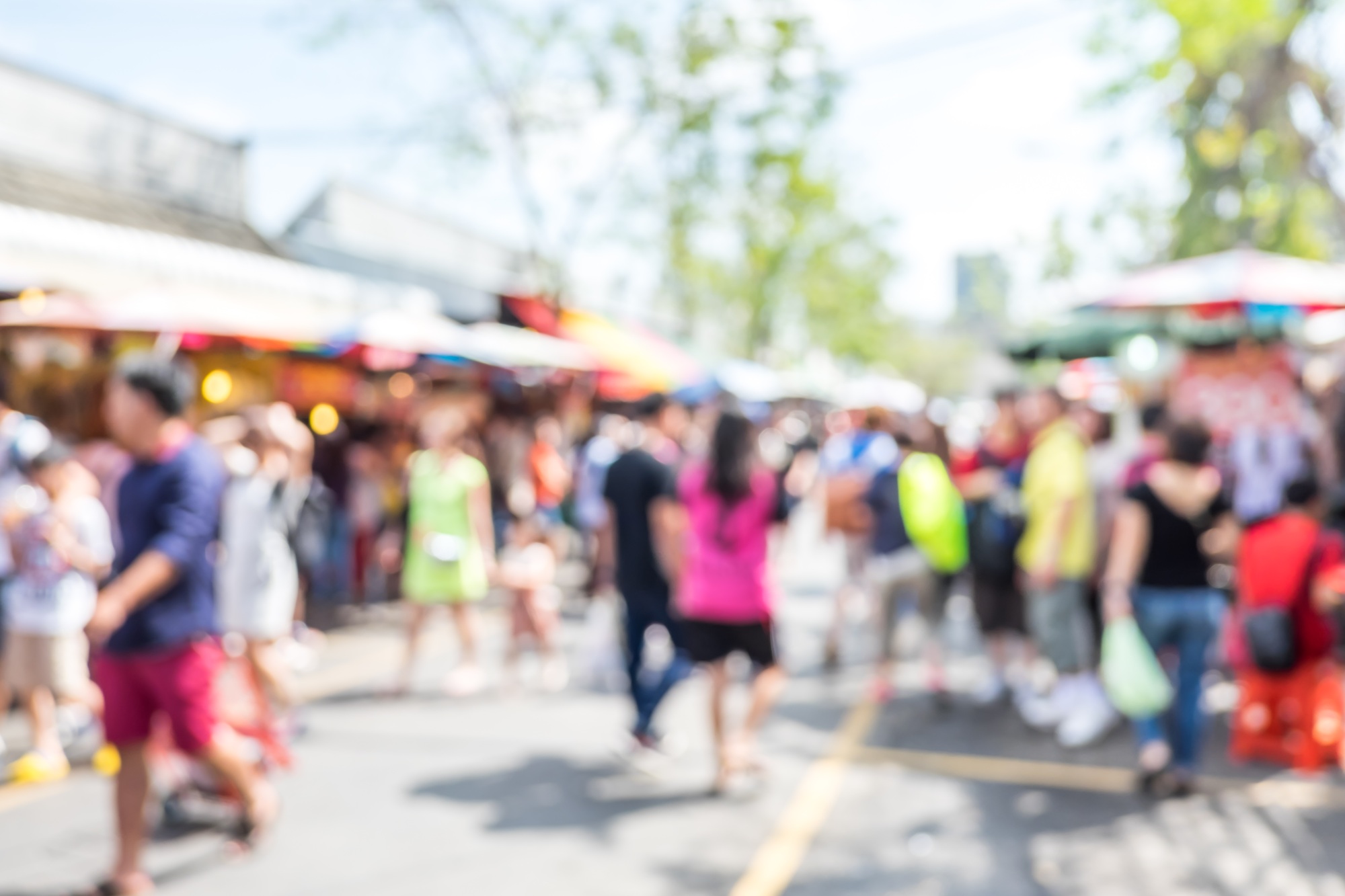 Blurred background : people shopping at market fair in sunny day, blur background with bokeh