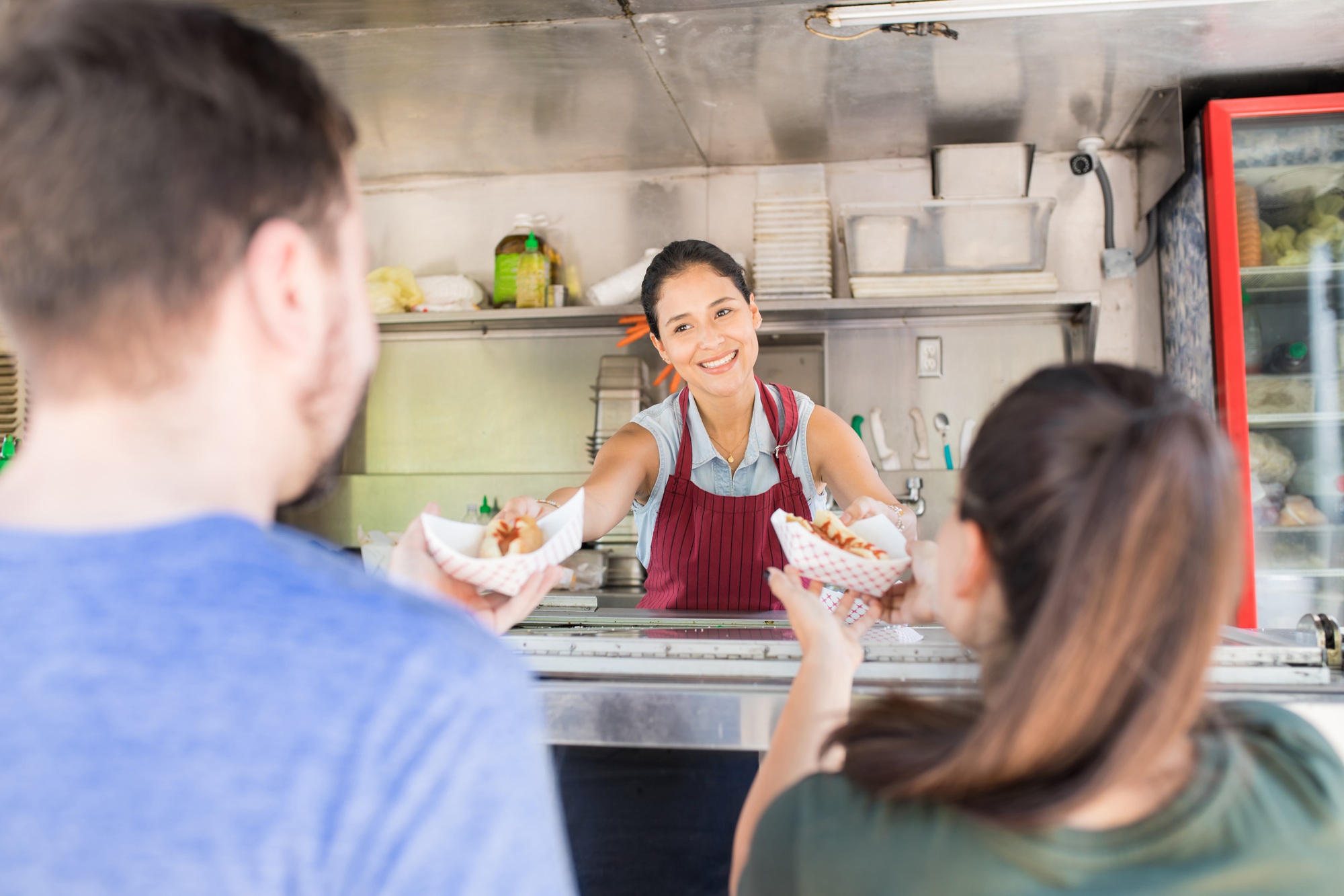 Food truck owner selling hot dogs