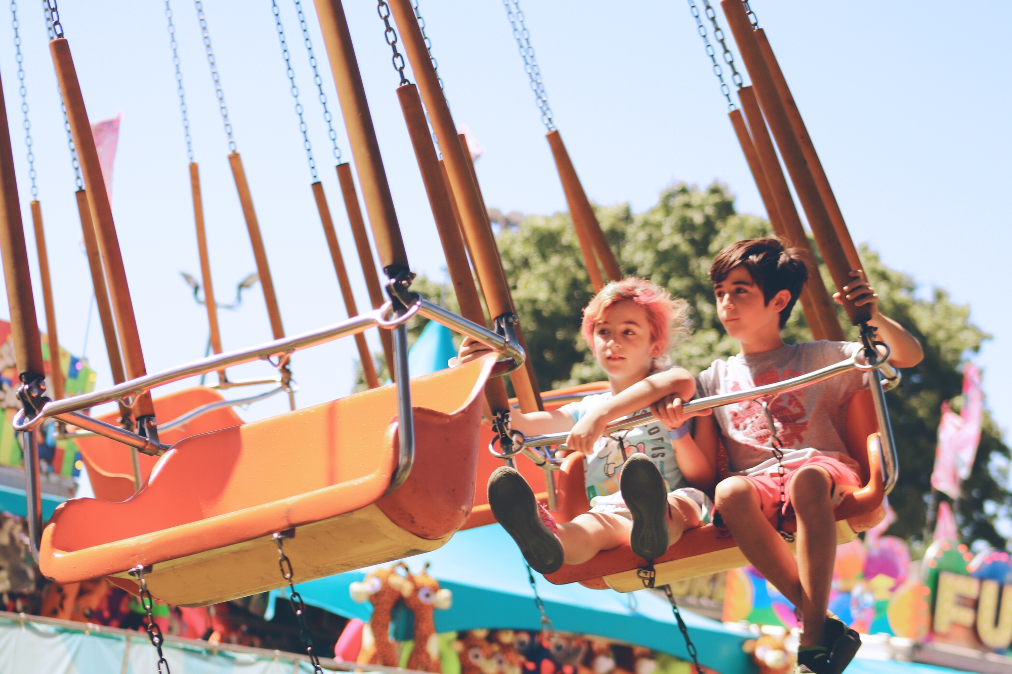 Kids on swing ride at county fair.