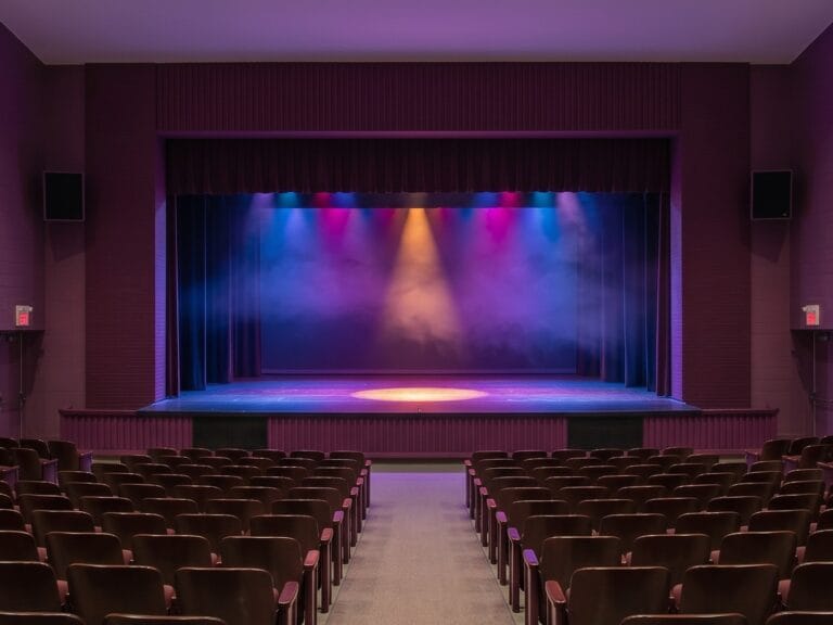 Empty theater stage with colorful spotlight lighting